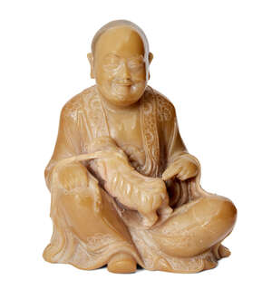 
	
		A Chinese soapstone figure of a Luohan, 18th/19th century, carved seated holding a...