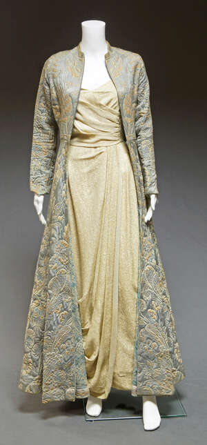 
	
		A gold lurex evening gown, c.1950s, Vogue Couturier Design, the sleeveless gown with...