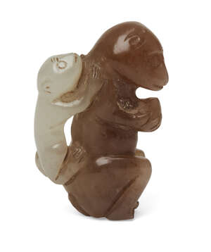 
	
		A Chinese two-colour jade monkey group, 19th century, carved as a crouching monkey...