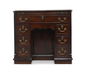 
	
		An early George III mahogany kneehole desk, with brushing slide above arrangement of...