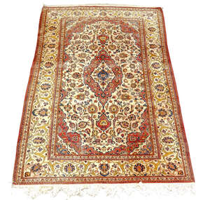 
	
		A Kashan rug , mid 20th century, with red medallion in floral decorated ivory field, with...