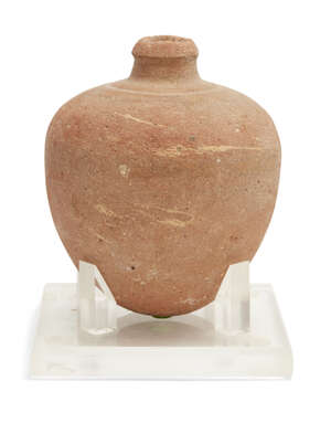 
	
		A Bronze Age buff pottery vessel 
		Circa 1500-1200 B.C.
		With bulbous tapering body,...
