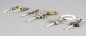 
	
		A collection of baby's silver rattles and teethers, to include  a double child's face...
