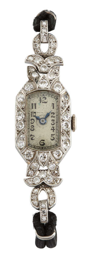 
	
		A lady's Art Deco platinum and diamond wristwatch, the rounded rectangular dial with...