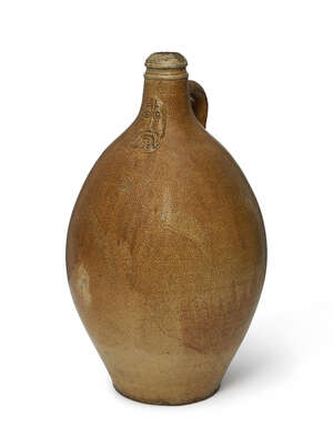 
	
		A large German Bellermine salt glazed stoneware bottle, 17th century, of typical form...