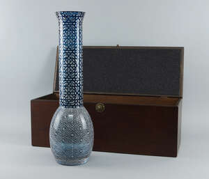 A Middle Eastern blue and white glass vase, of recent manufacture, of tall design inset with geometric motifs to the neck and line designs to the ovoid body, 5