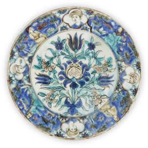 
	
		A Qajar underglaze painted pottery dish, mis-fired, Iran, 19th century, of shallow form,...