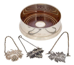 
	
		A silver wine coaster with turned wood base, Birmingham, c.1953, W I Broadway & Co., with...