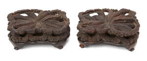 
	
		A pair of Chinese hardwood stands, 19th century, carved as waves, possibly for export...