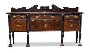 
	
		An Irish mahogany sideboard, early 19th Century, the gallery back, with carved central...