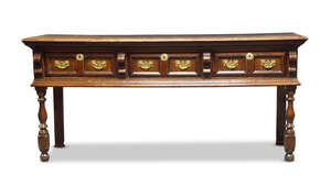 
	
		A Charles II oak dresser, c.1680, the moulded top above three twin-panelled frieze...