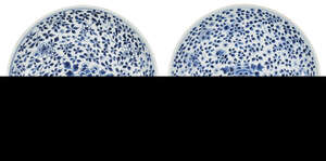 A pair of Chinese porcelain 'peony' dishes, Kangxi period, painted in underglaze blue with flowering peony stems, underglaze blue double circle to base