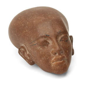 
	
		An Egyptian style brown quartzite head of an Amarna style princess, with elongated skull...