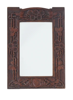 An Art Nouveau carved oak mirror, first quarter 20th century, set with bevelled plate, 76 x 53cm