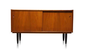 
	
		Attributed to Arne Hovmand Olsen (1919-1989), a teak sideboard  
		c.1960 
		with two...