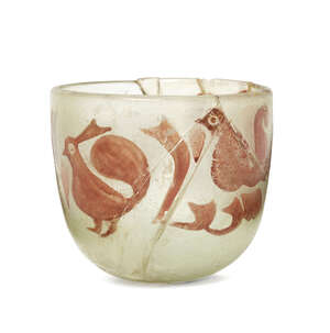
	
		A lustre-painted glass vessel, Iran, of deep form, the thick greenish glass decorated to...
