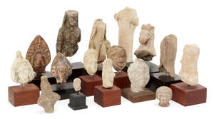 A group of sixteen fragmentary mainly ancient terracottas, including an archaising female figure wearing close-fitting drapery, 13cm; a Hellenistic naked youth