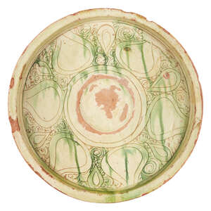 
	
		A large Byzantine scraffiato ware plate, 13th-14th century, with green glaze and incised...