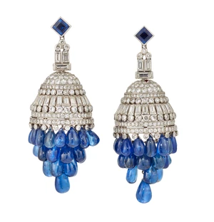 A pair of Art Deco platinum, diamond and sapphire earrings, the central domed panel set with...