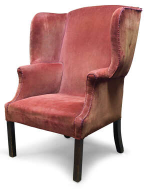 
	
		A George III wingback armchair, with serpentine wings, upholstered in red velvet, raised...