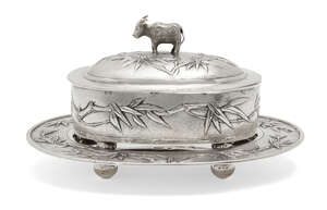 
	
		A Chinese silver oval butter dish and stand, Zee Sung, the cover with buffalo finial,...