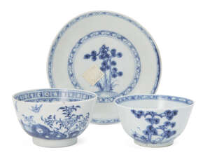 A Chinese porcelain tea bowl and saucer, 18th century, painted in underglaze blue with pine trees, excavated from the Nanking shipwreck, 12cm diameter of sauce