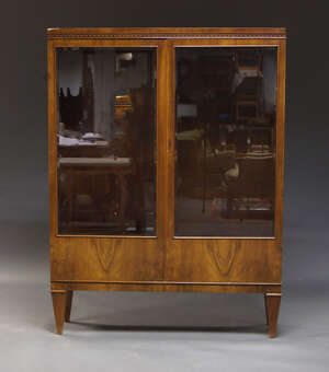 
	
		A French walnut vitrine bookcase, with applied blind fret carved frieze, above two glazed...