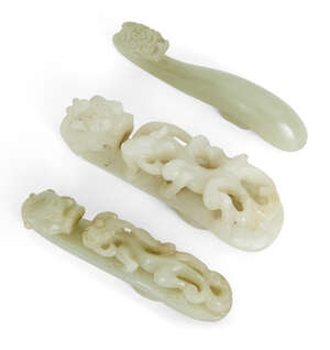 
	
		Three Chinese jade 'dragon' belthooks, 18th/19th century, one carved with dragon head...