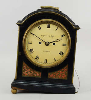 
	
		A Regency ebonised wood and brass mounted mantel clock by Wightwick and Moss, the case...