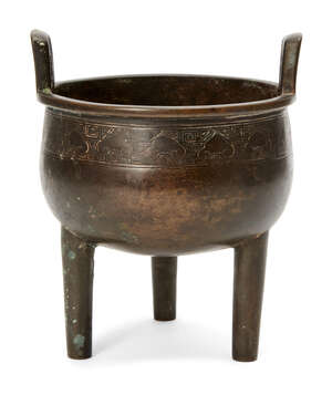 
	
		A Chinese bronze tripod censer, ding, 18th/19th century, with band of ruyi head and Greek...