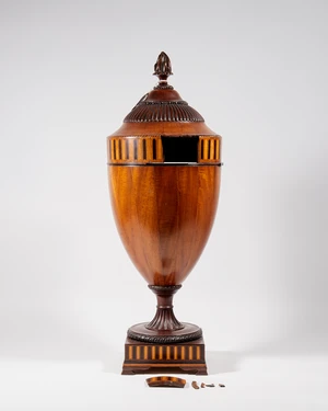 A George III mahogany urn shape knife box, with ebony and fruitwood stringing and inlaid frieze...