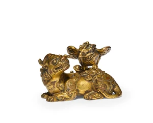 A Chinese gilt-bronze 'Luduan and Garuda' group 
Qing dynasty, 17th/18th century 
Finely cast with archaistic motifs in shallow relief, the surface gilded th