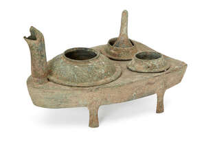 
	
		A Chinese bronze zoomorphic stove, Han dynasty, modelled as a stylised turtle, with head...