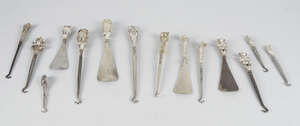 
	
		A good collection of silver novelty button hooks and shoe horns, to include a a button...
