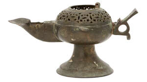 A Khorasan openwork oil lamp, Iran, 12th century, on trumpet foot, the round body with openwork lattice shoulder, engraved roundels to sides, the fan-shaped th