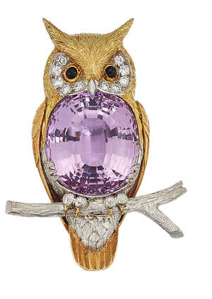 
	
		A kunzite and diamond owl brooch, modelled as a two-colour owl perched on a tree branch,...
