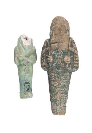 
	
		A large fragmentary Egyptian shabti figure, moulded with crossed hands, the body with...