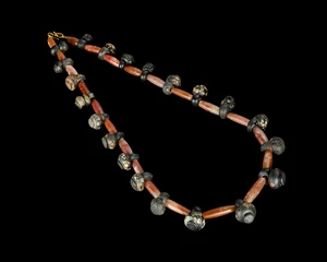 A glass bead and carnelian necklace,Probably late Roman circa late 6th-4th century ADComposed of...