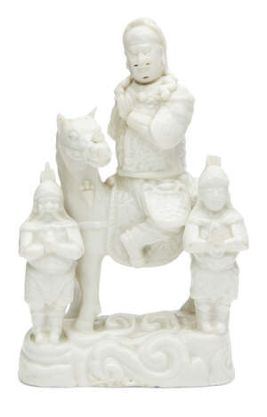 A Chinese blanc de chine figure group, Kangxi period, modelled as Guandi on horseback beside two attendants, 20.5cm high
		Provenance: Paper collection label 