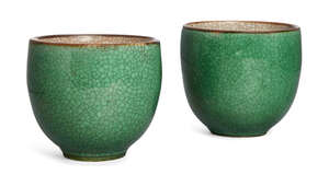 A pair of Chinese porcelain apple-green glazed cups, 18th century, the exterior covered with apple-green glaze suffused with black lines, the interior with gre