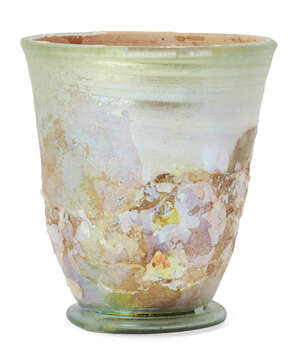 A Roman pale green glass beaker on a folded ring base, with wheel-abraded bands below the rim,...