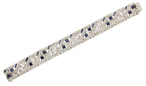 
	
		A diamond and synthetic sapphire bracelet, of broad articulated panel design, set with...