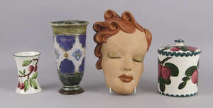 A Wemyss pottery biscuit barrel and lid, decorated with plums, impressed and printed mark to base, 15.5cm high, together with a small waist form jar, decorated