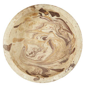 
	
		A marbled pottery dish, possibly Byzantine, 10th-12th century or later, on a short foot...