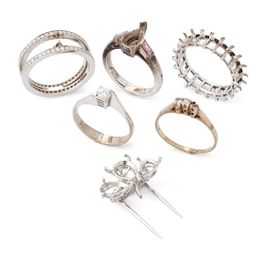 A group of mounts, comprising four ring mounts two stamped 750, one a diamond twin band, and a...