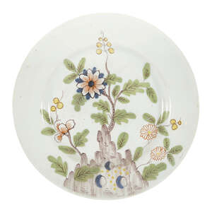 
	
		A Liverpool delft plate, c.1760, painted in the Fazackerley palette with flowers and...