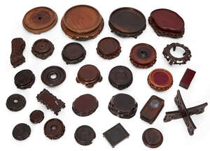 
	
		Twenty-eight Chinese and Japanese wood stands, 18th-20th century, one with sterling...