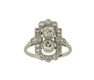 
	
		An Art Deco, diamond panel ring, millegrain-set in the centre with two old-brilliant-cut...