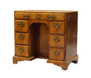 
	
		A George I walnut and feather banded kneehole desk, c.1730, the rectangular quarter...
