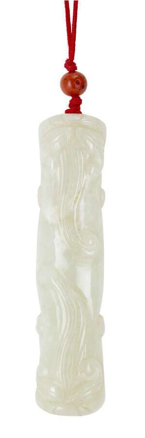 A Chinese pale green jade pendant, 19th century, carved with dragon heads with flowing manes at...